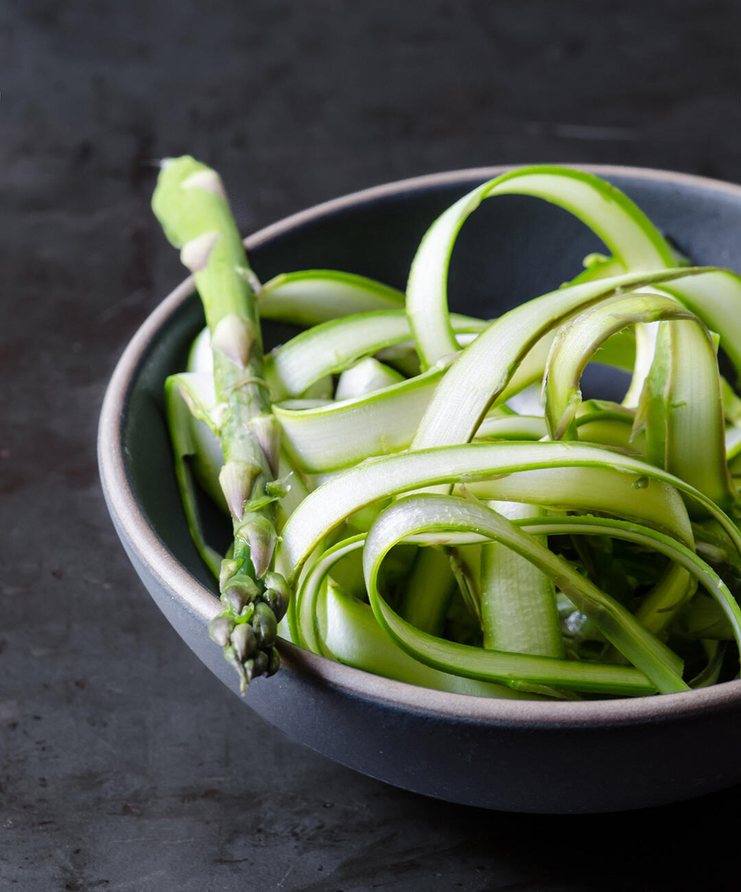 Bowl of shaved asparagus.